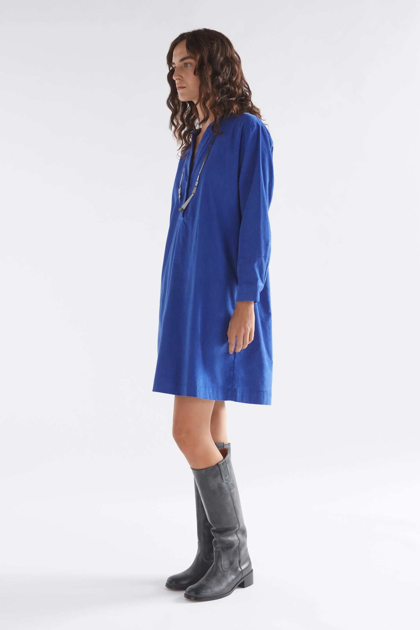 Luna Collection Above-knee cord dress Ultramarine Blue Half placket sits apart at the neck Dropped shoulder Twin needle stitching details on back yoke and forearm Fine cord fabric is soft and warm to the touch